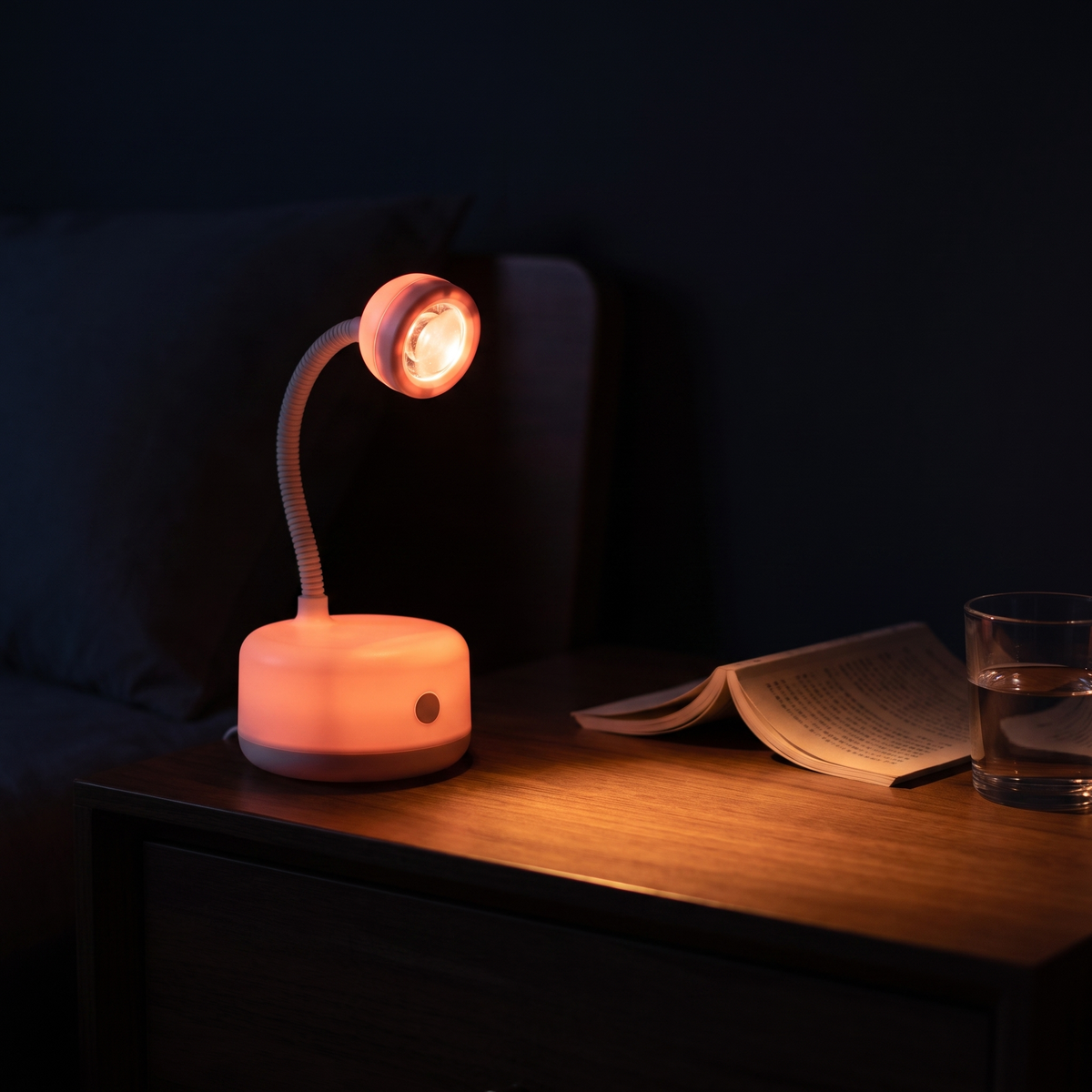 Lunaro Halo in warm amber night light mode on a bedside table